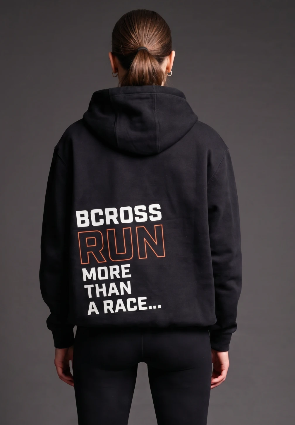 Bcross Run hoodie product shot — woman in black BCROSS RUN MORE THAN A RACE hoodie